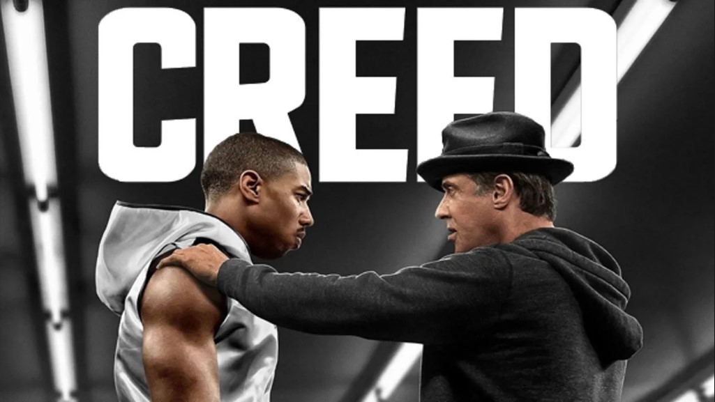 Creed: Rise to Glory promotional artwork featuring Michael B. Jordan as Adonis Creed and Sylvester Stallone as Rocky Balboa in a high-contrast black and white style.